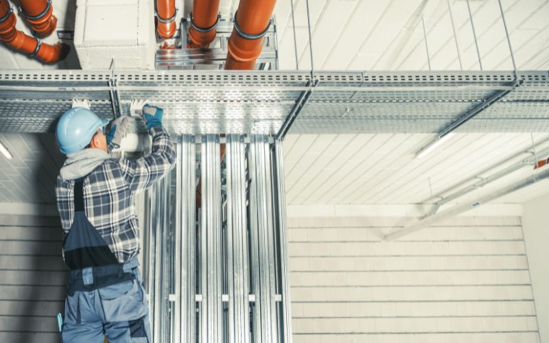 Empire Electric professional performing meticulous conduit installation in a Morgan Hill commercial building, ensuring top-grade electrical infrastructure.